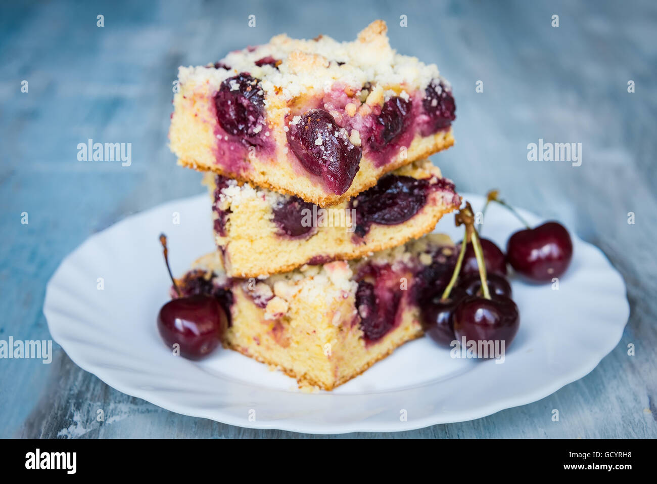 Slices of home made butter cherry cake with crumble topping Stock Photo