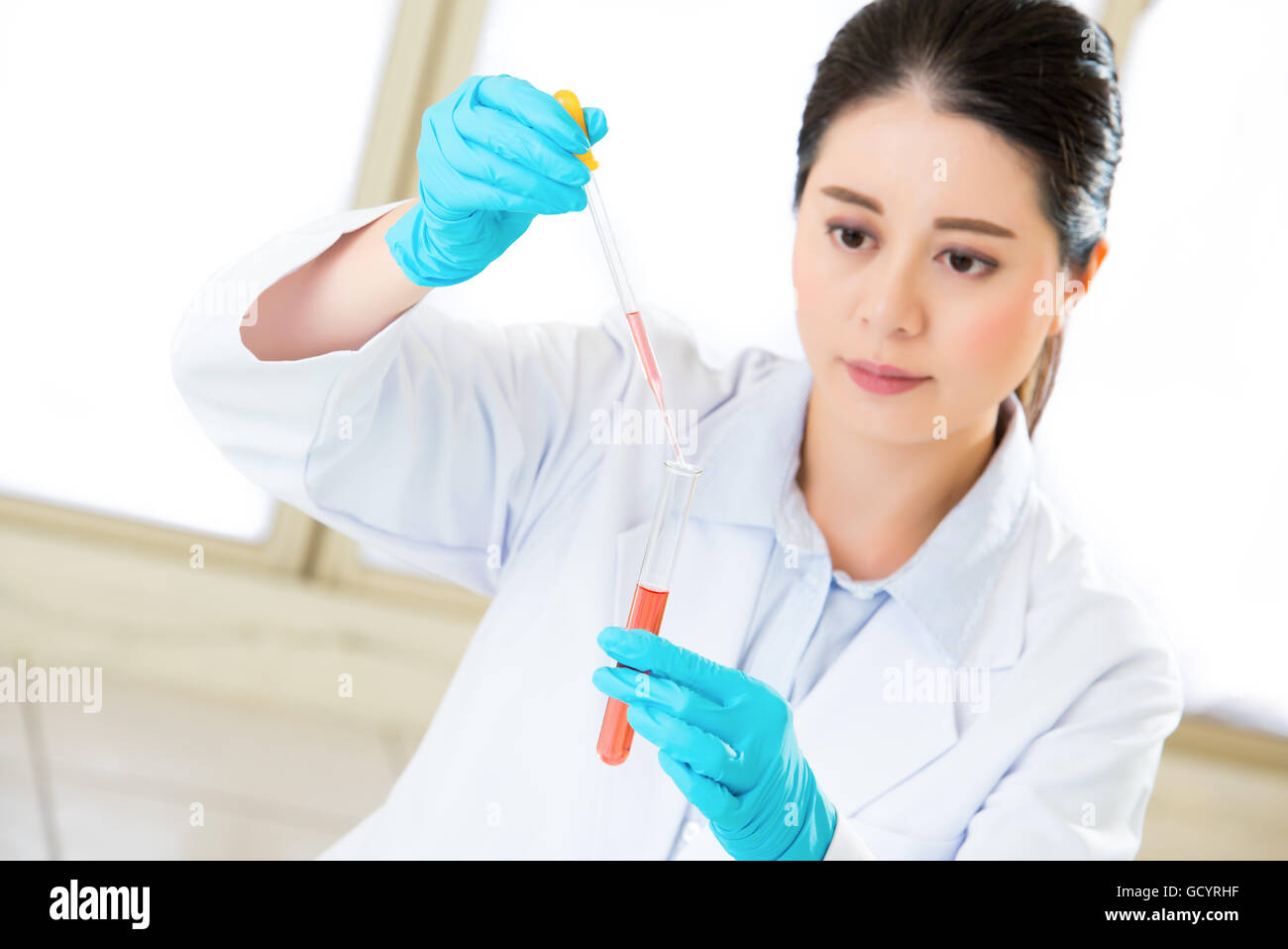 scientist breaking scientific boundaries with her research  with gloves Stock Photo