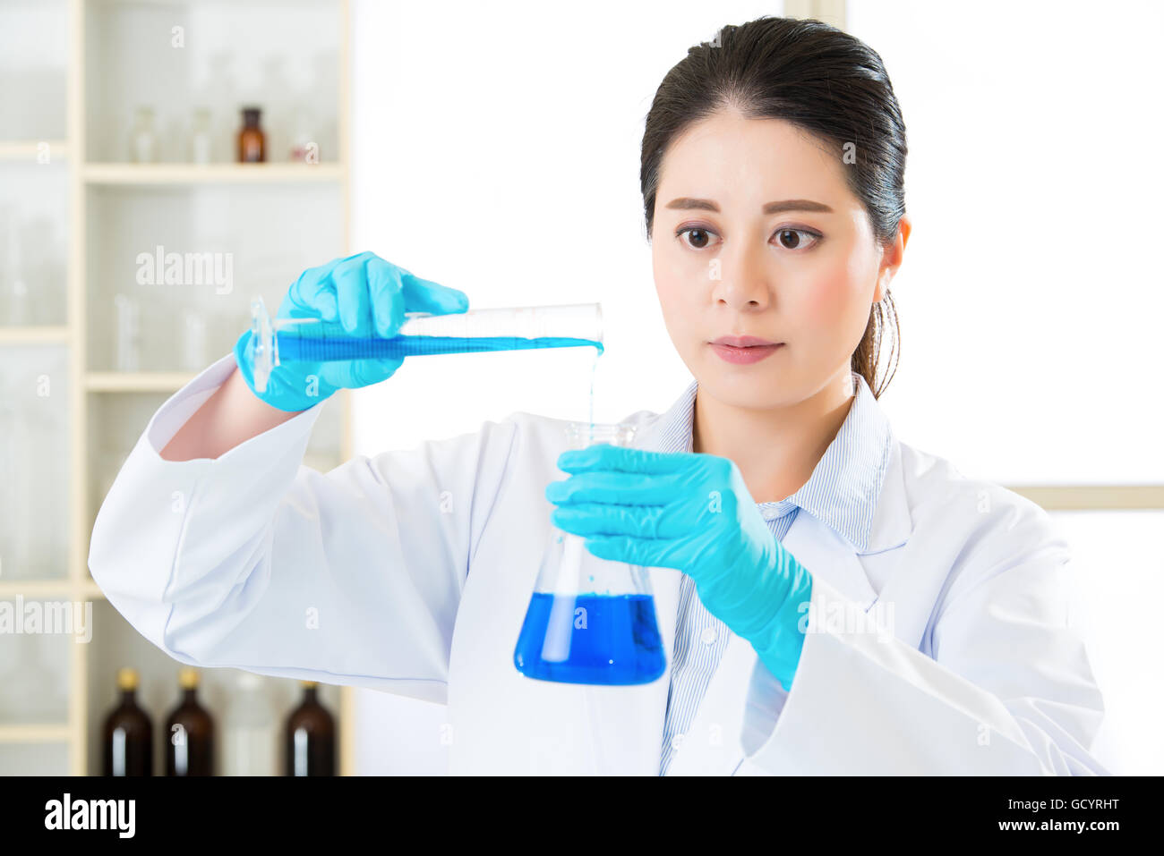 Young asian scientist Braving new medical frontiers in laboratory with gloves Stock Photo