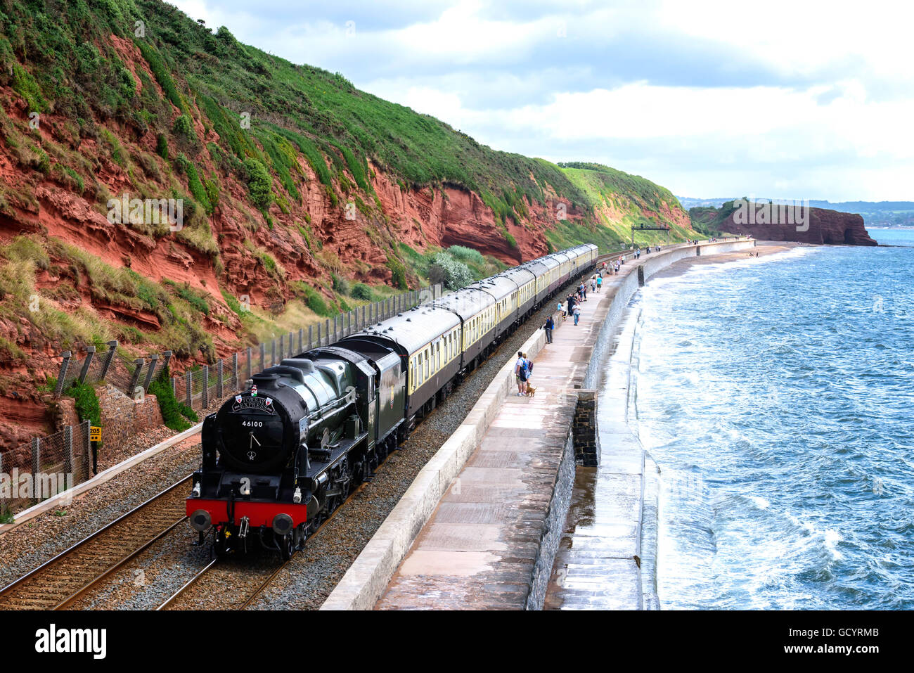 Steam locomotive 46100 Royal Scot hauls The Torbay Express along the Sea Wall at Dawlish south Devon UK Stock Photo