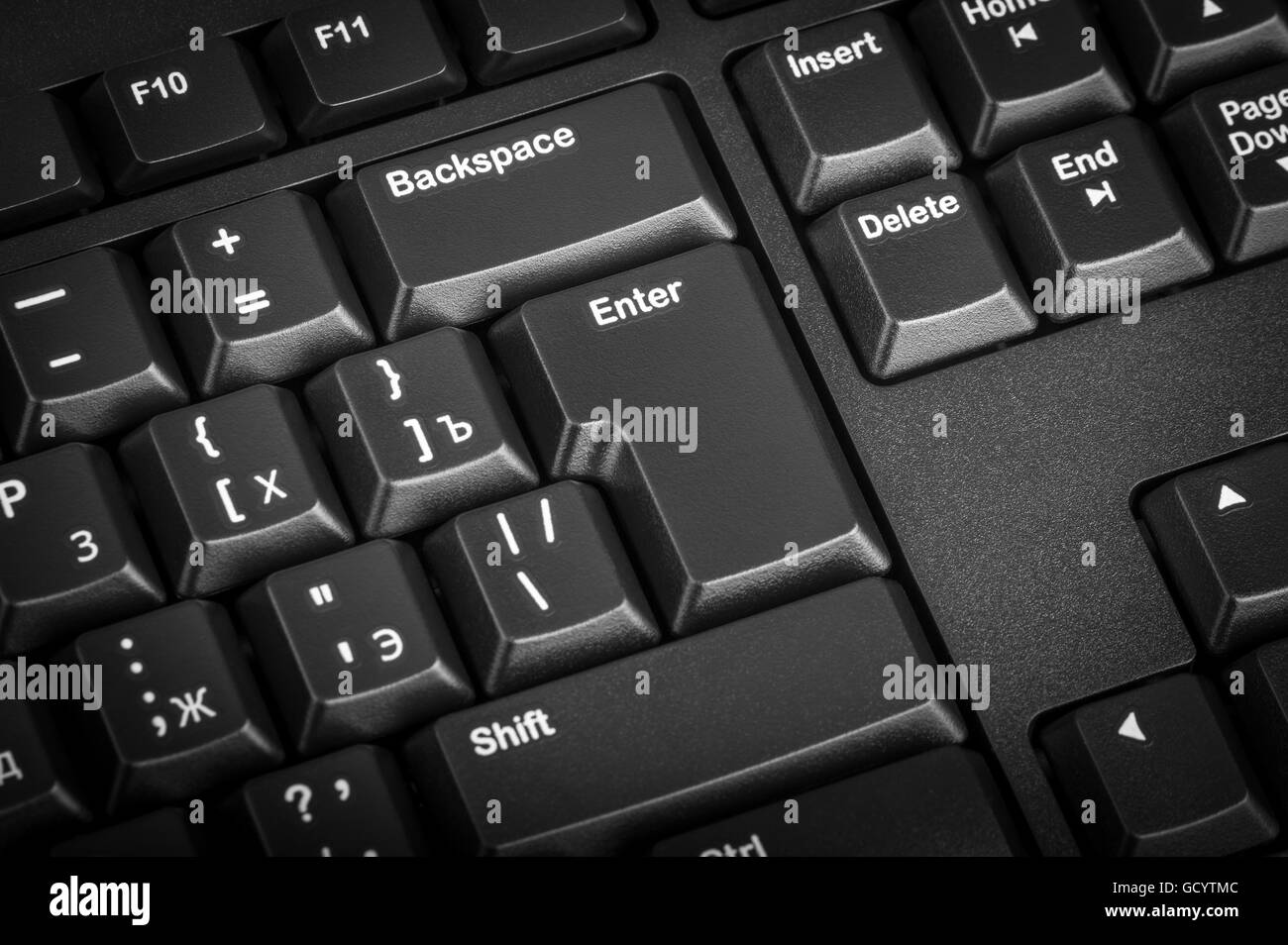 Electronic collection - close-up black computer keyboard with russian letter. The focus on the Enter key. Stock Photo