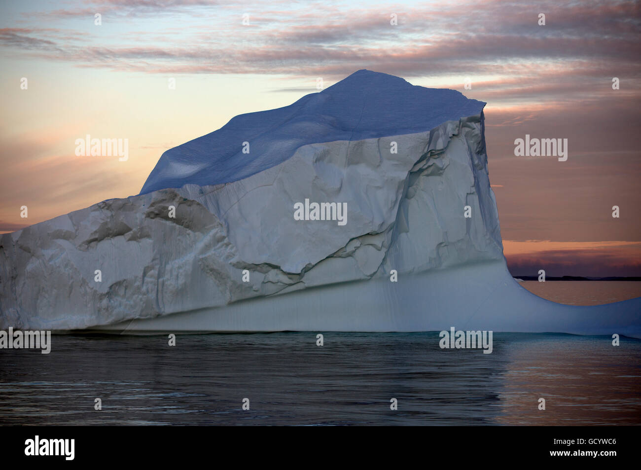 Iceberg under the midnight sun off the west coast of Greenland Stock Photo