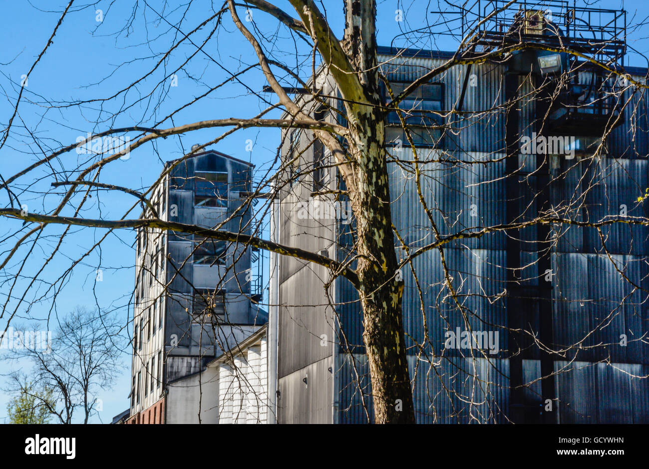 Old blackened metal buildings with old grain mill structures on the
