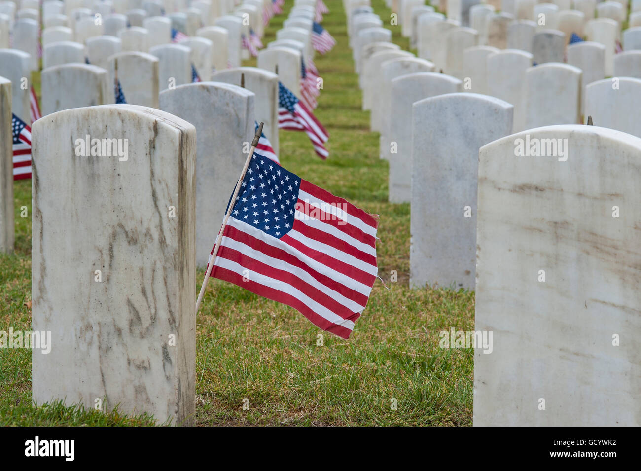 Memorial Day Ceremony at cemetery with American Flags at grave sites Stock Photo