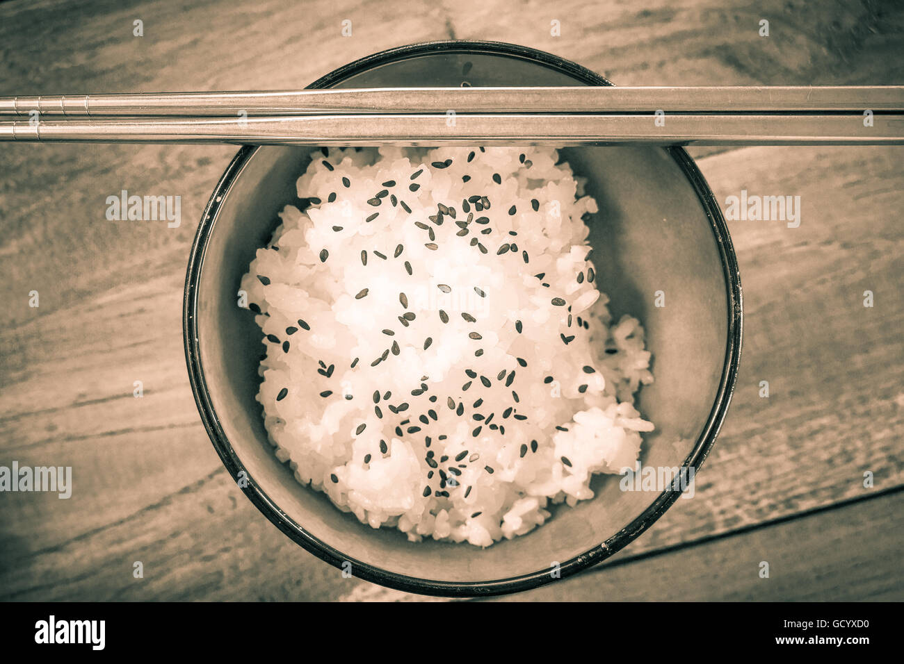 White Jasmine Rice in Asian Bowl with Black Sesame Seeds with sepia photo technic - Stock Image Stock Photo
