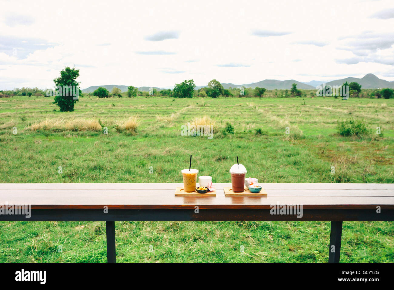 iced coffee and biscuit alphabet with rice field background Stock Photo ...
