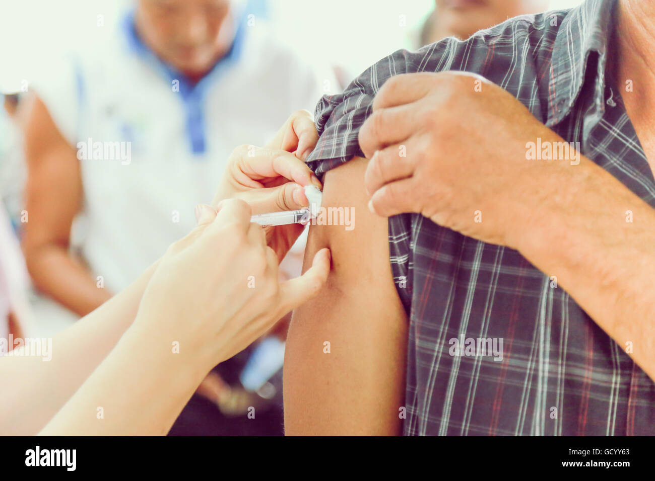 Shot of human hands making an injection with a syringe Stock Photo