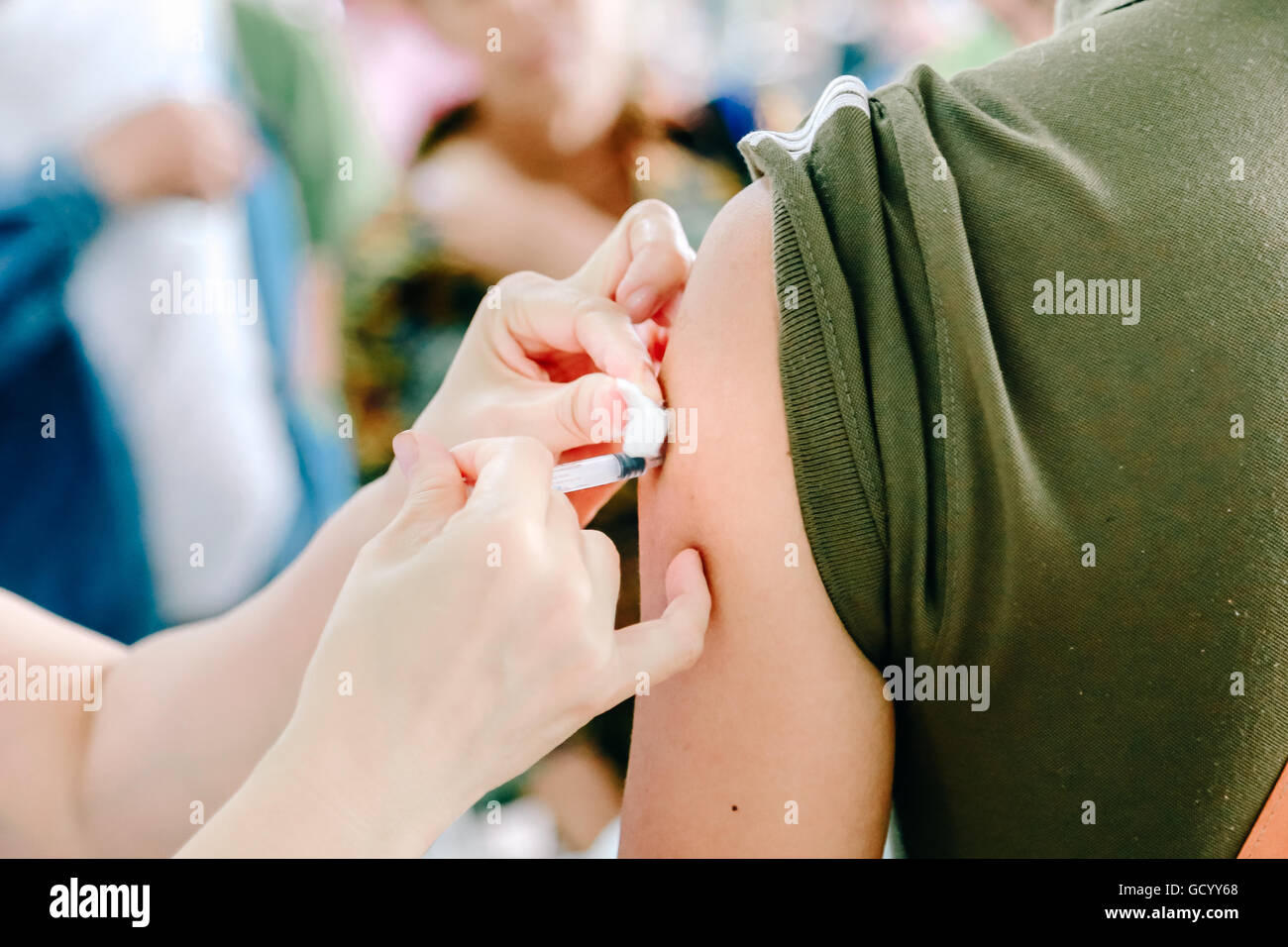 Shot of human hands making an injection with a syringe with isolate ...