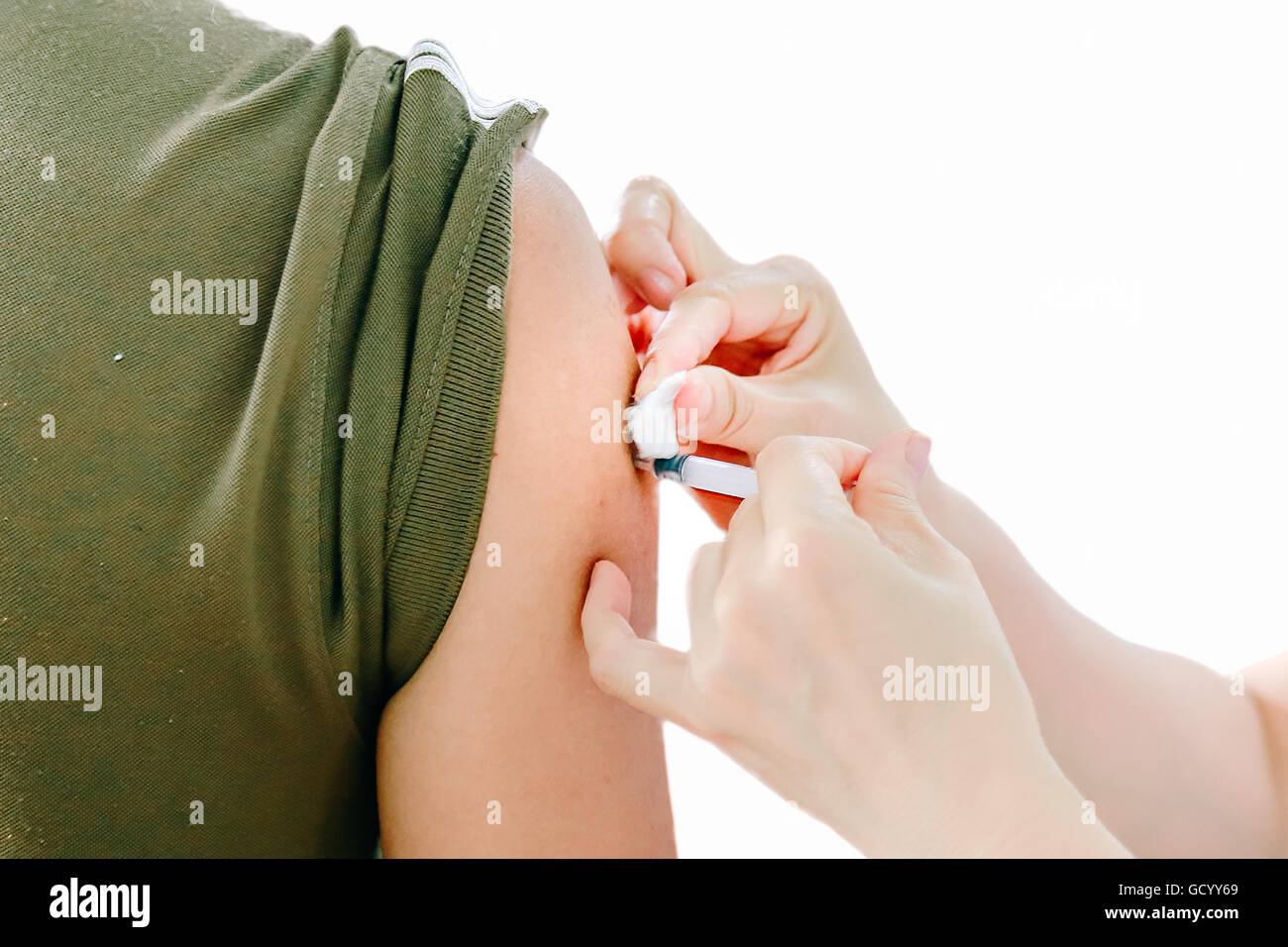 Shot of human hands making an injection with a syringe with isolate ...