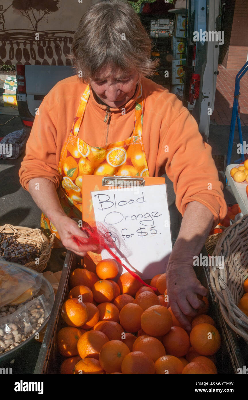 The Orange Lady at Elwood Farmers' Market, Melbourne Stock Photo