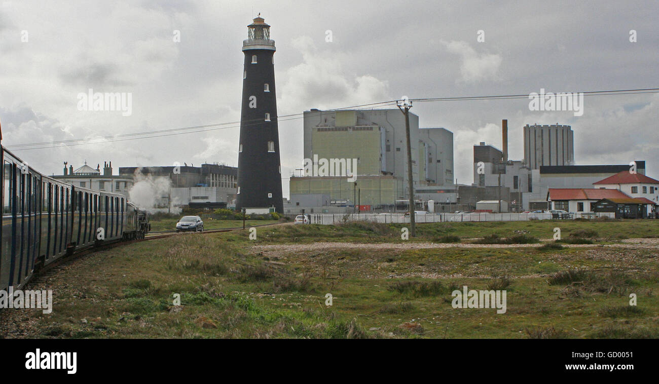 Romney Hythe and Dymchurch Railway train leaves Dungeness past the old Lighthouse and Power Station Stock Photo