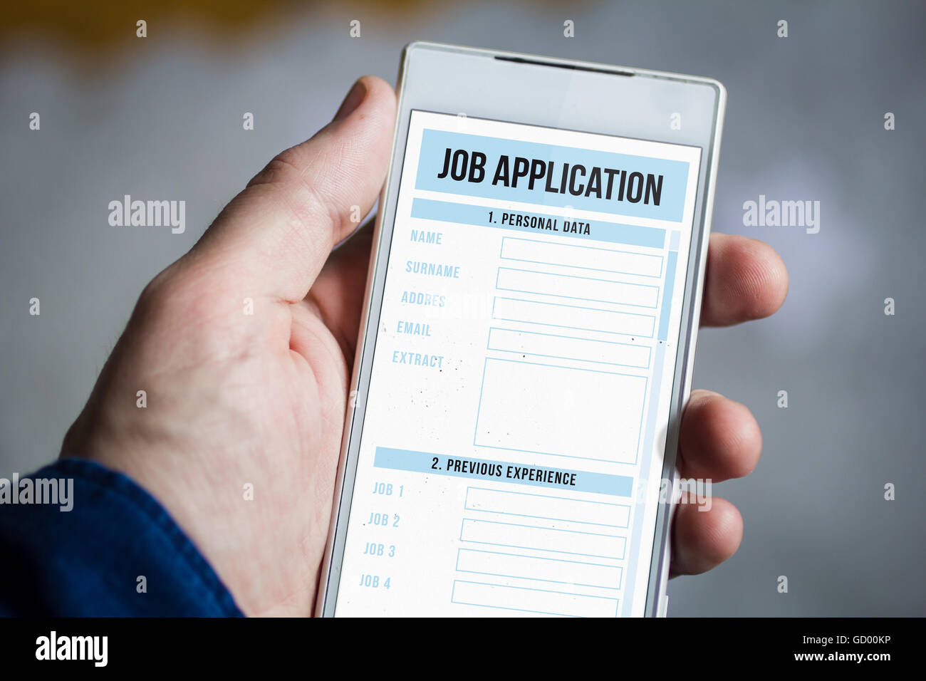 man hand holding job application smartphone. All screen graphics are made up. Stock Photo