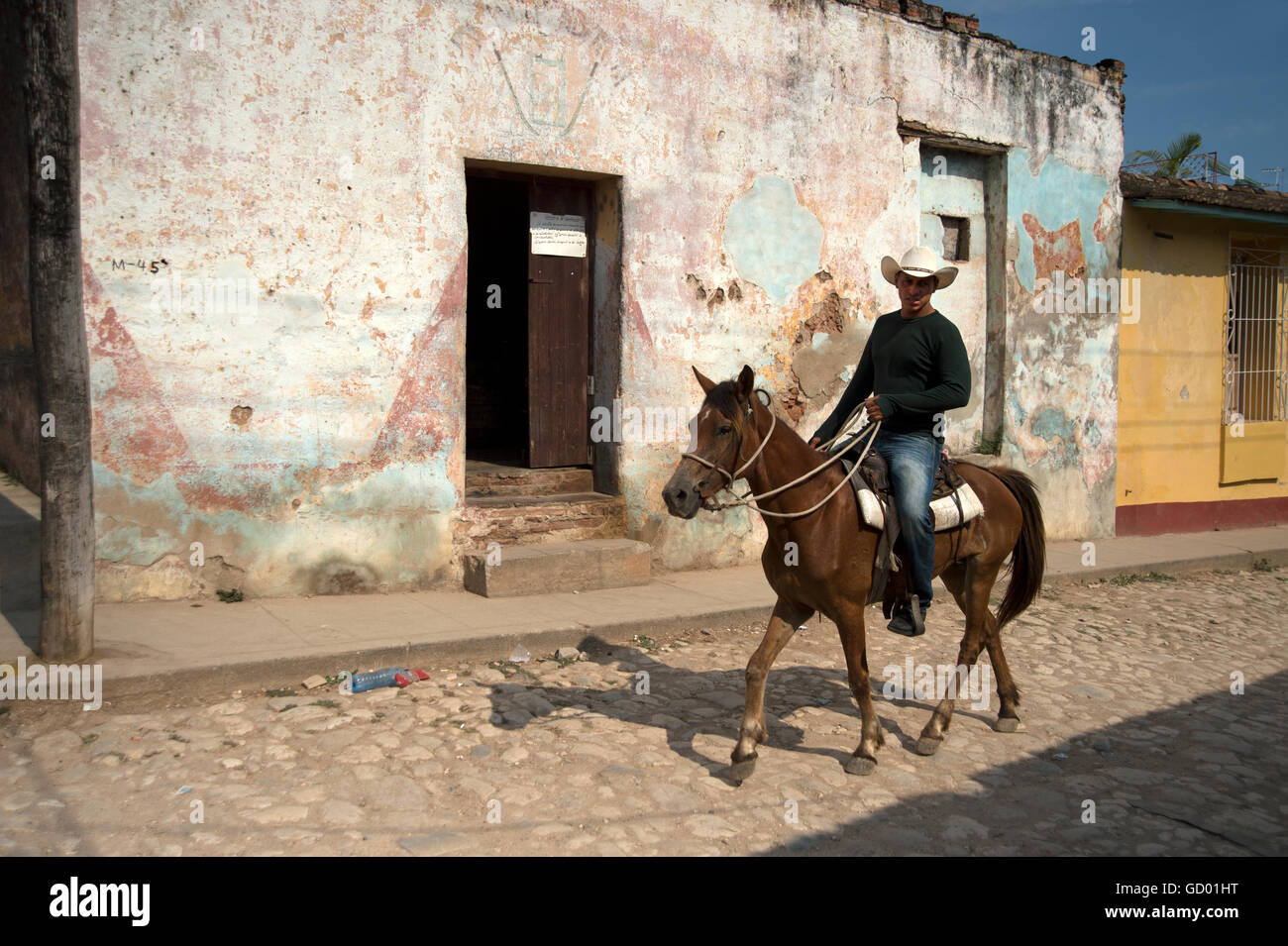 A lone Cuban guarjiro or cowboy riding home after a hard days work on a countryside farm Trinidad Cuba Stock Photo