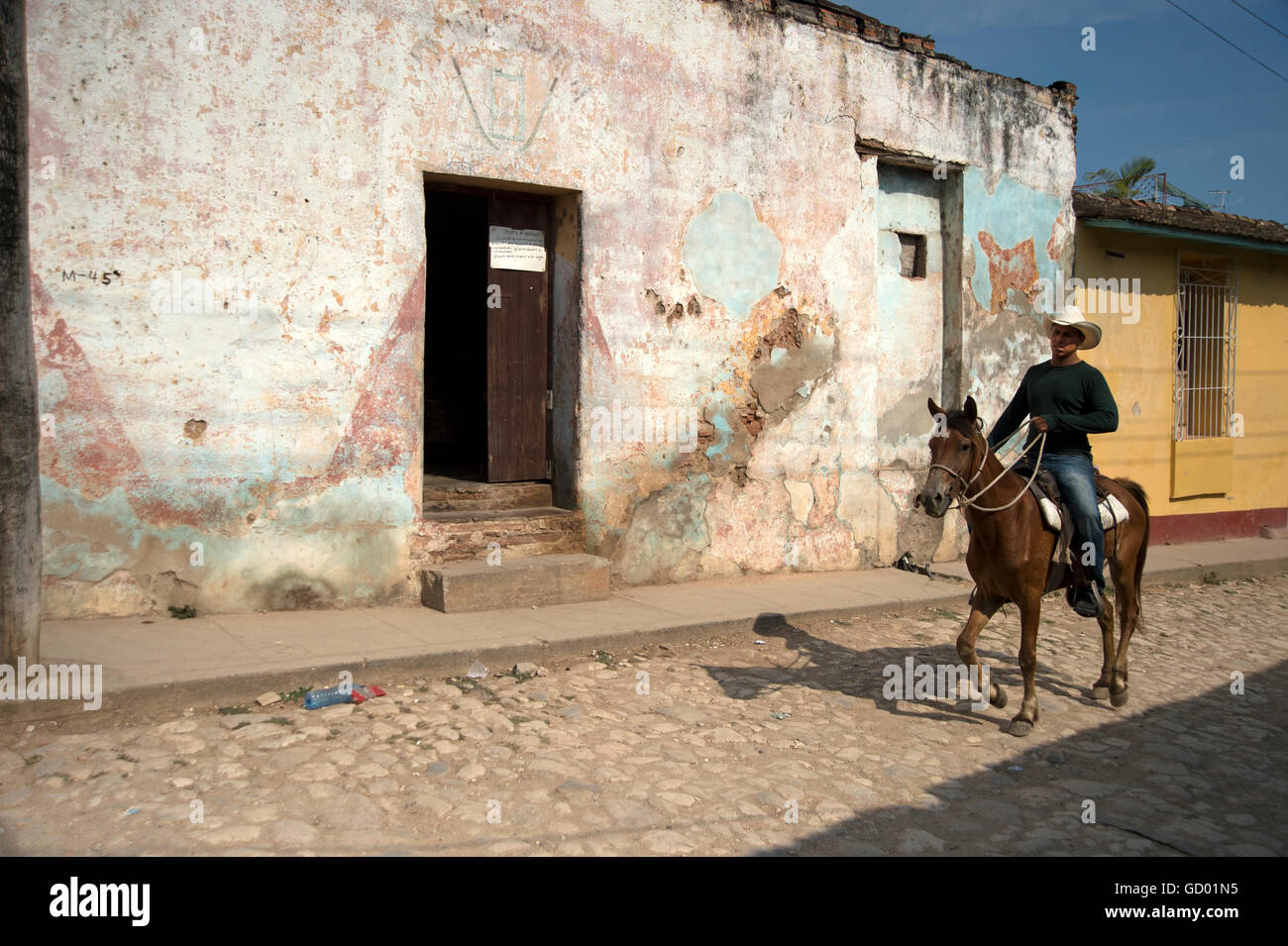 A lone Cuban guarjiro or cowboy riding home after a hard days work on a countryside farm Trinidad Cuba Stock Photo