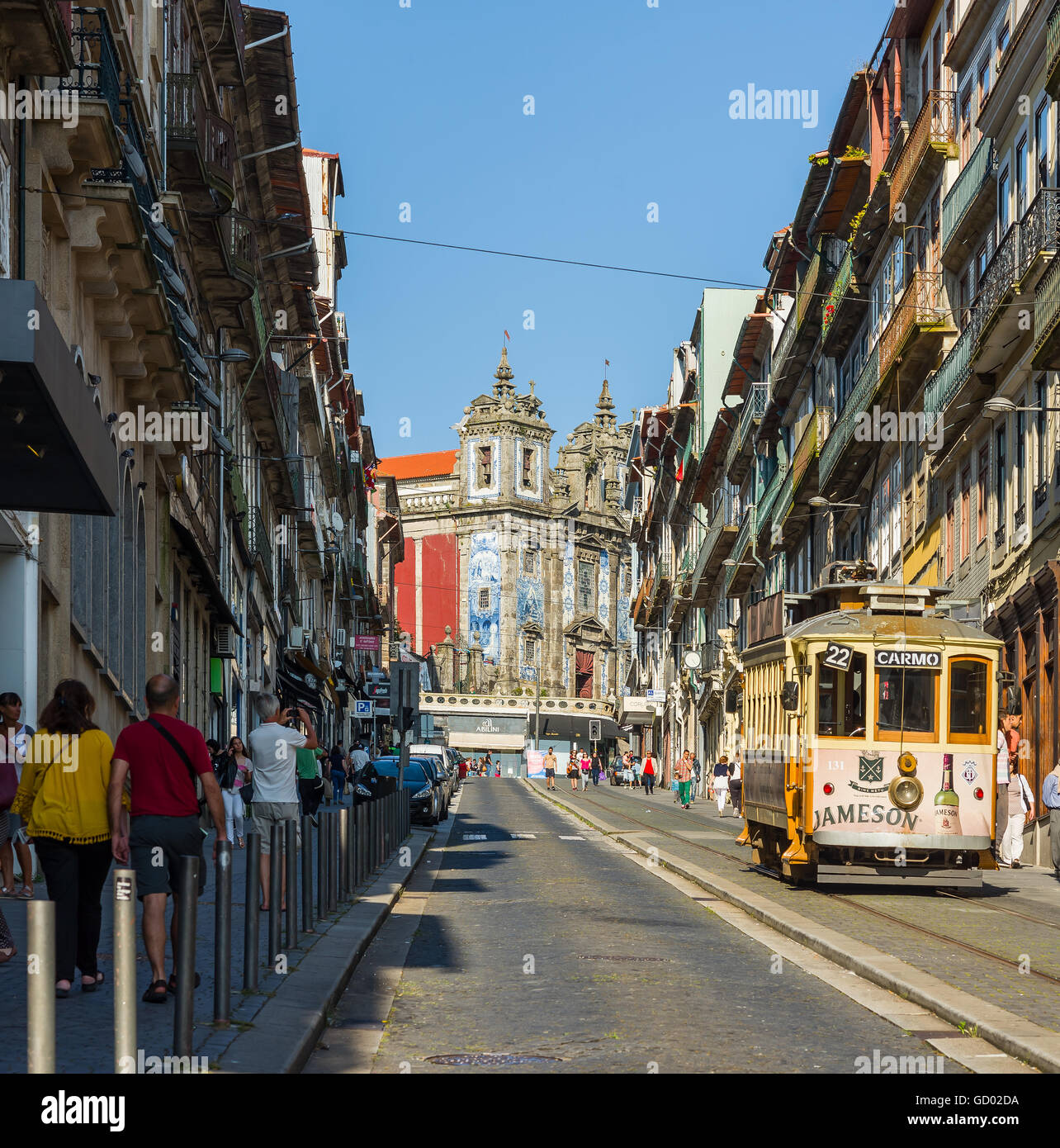 Tram crossing Rua 31 de Janeiro street with Igreja de Santo Ildefonso church in background. Porto. Portugal. Stock Photo