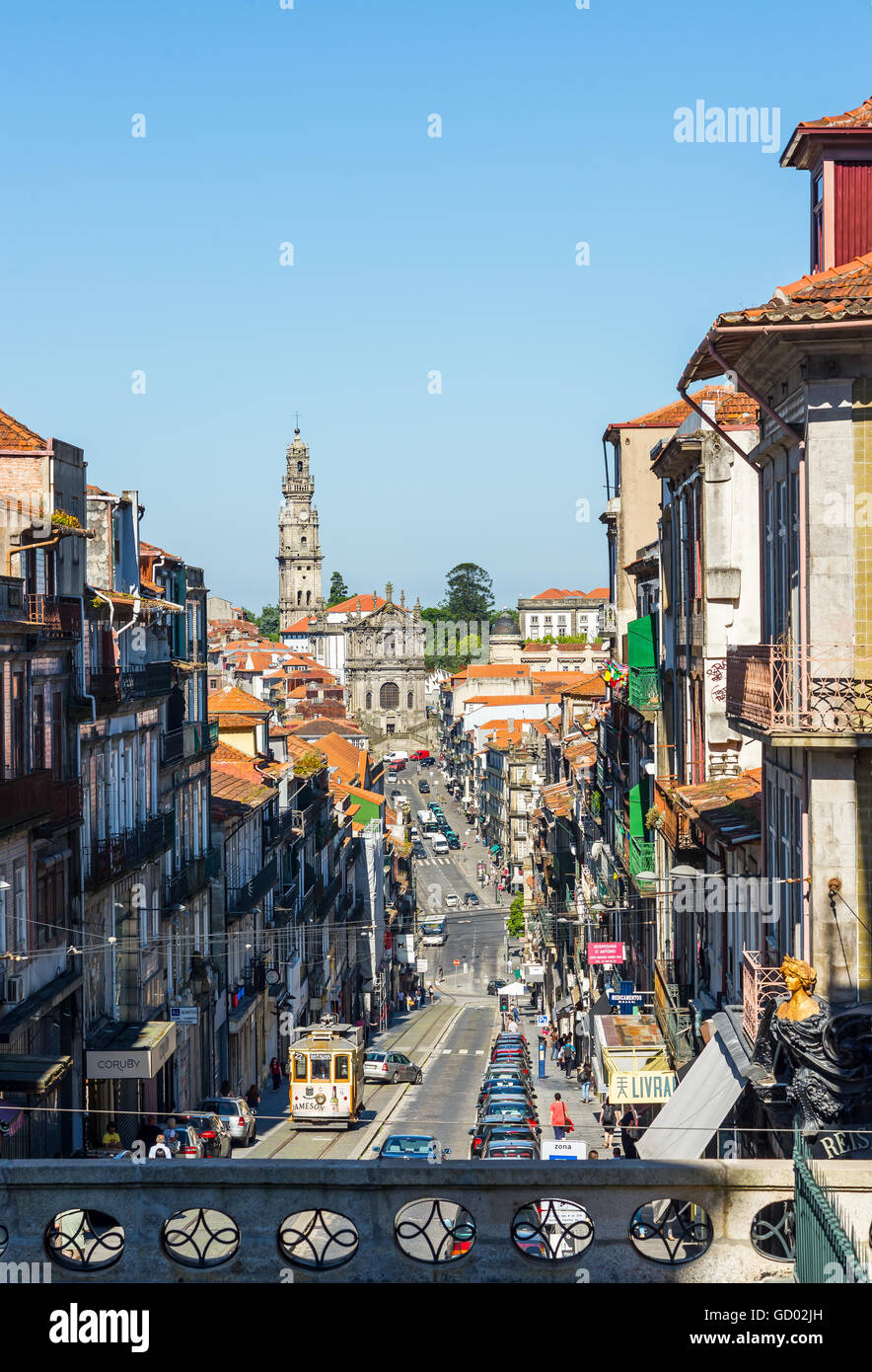 Tram crossing Rua 31 de Janeiro street with Igreja and tower dos Clerigos in background. Porto. Portugal. Stock Photo