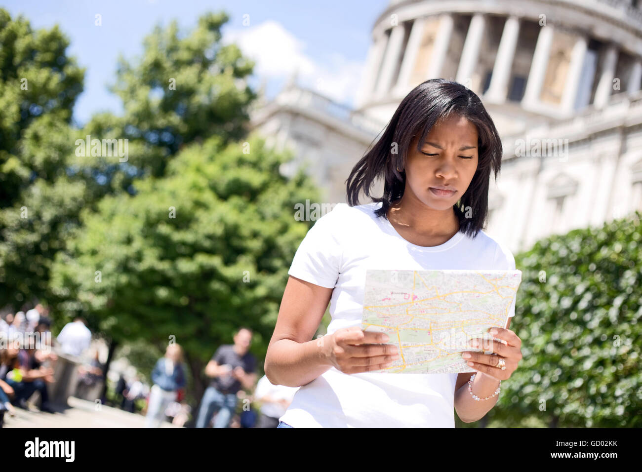young woman reading a map in London Stock Photo