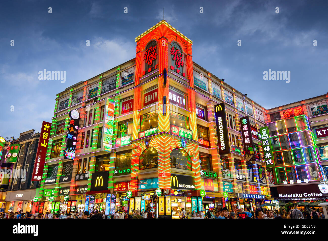 Pedestrians pass through Shangxiajiu Pedestrian Street in Guangzhou, China. Stock Photo