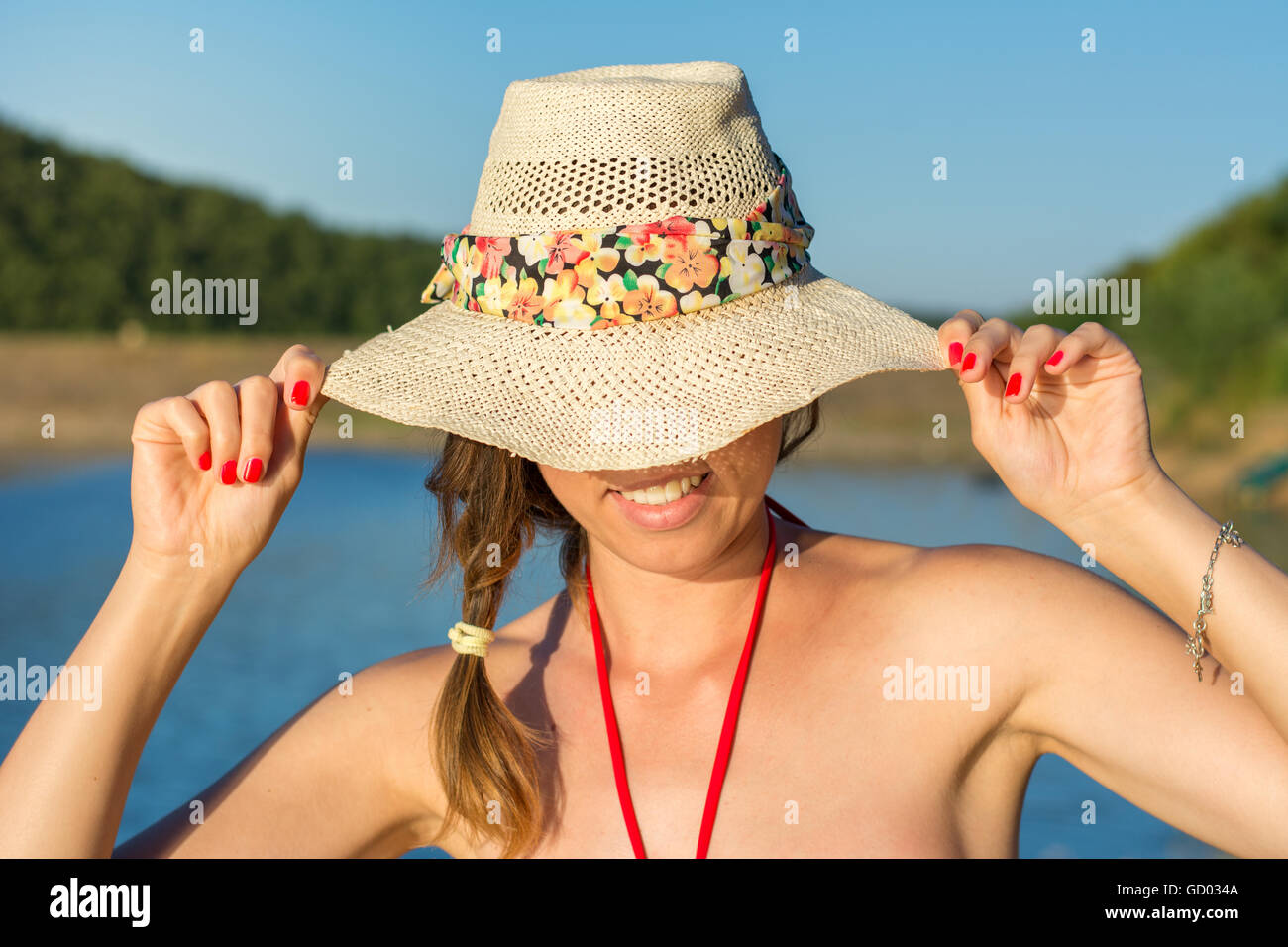 Portrait of beautiful women by the lake on summer vacation Stock Photo