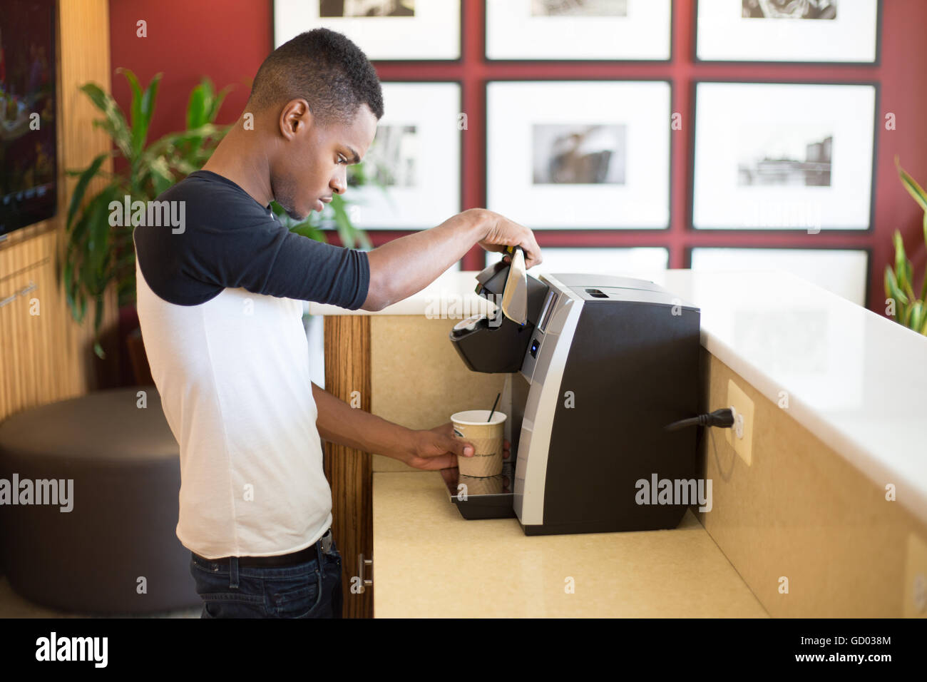 Closeup portrait, young guy making hot or iced coffee with machine