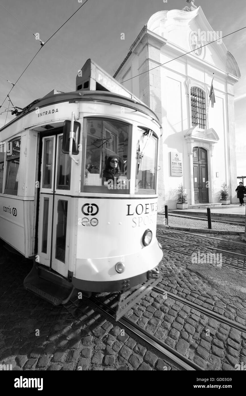 Trams Lisbon with sunlight casting patterns and shadows on the cobbles and tram tracks Stock Photo
