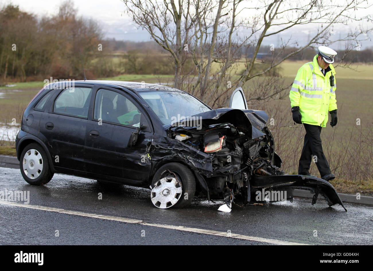 A Police Officer Views A Car After Four Vehicles Crashed On The M9 GD04XH 