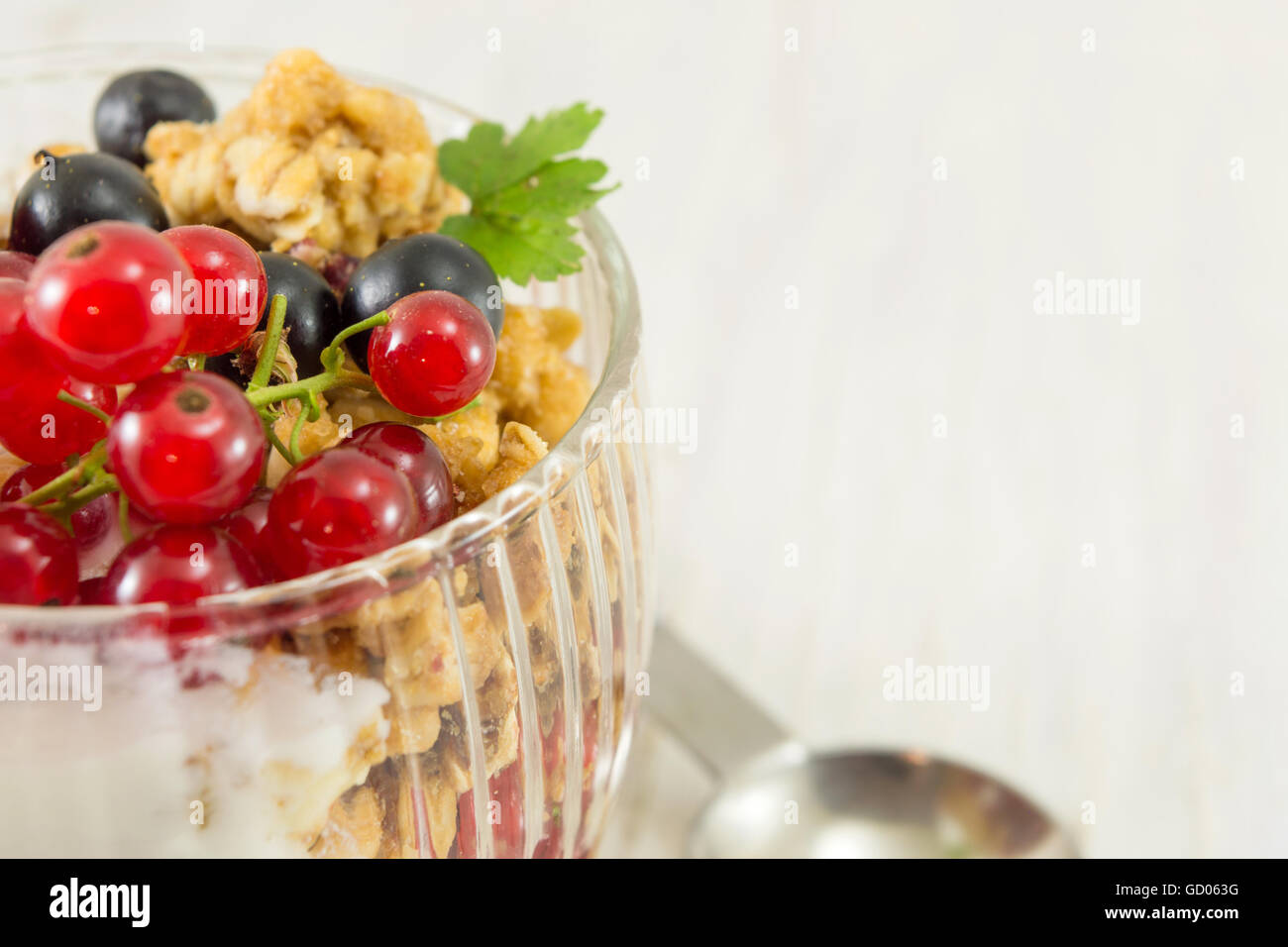 Granola parfait with berry fruit and cream. Healthy dessert Stock Photo