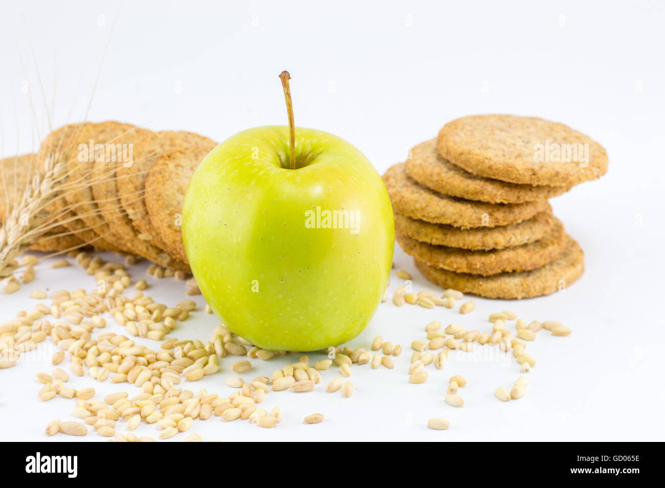 Integral biscuits with apple and wheat seeds on white background Stock Photo