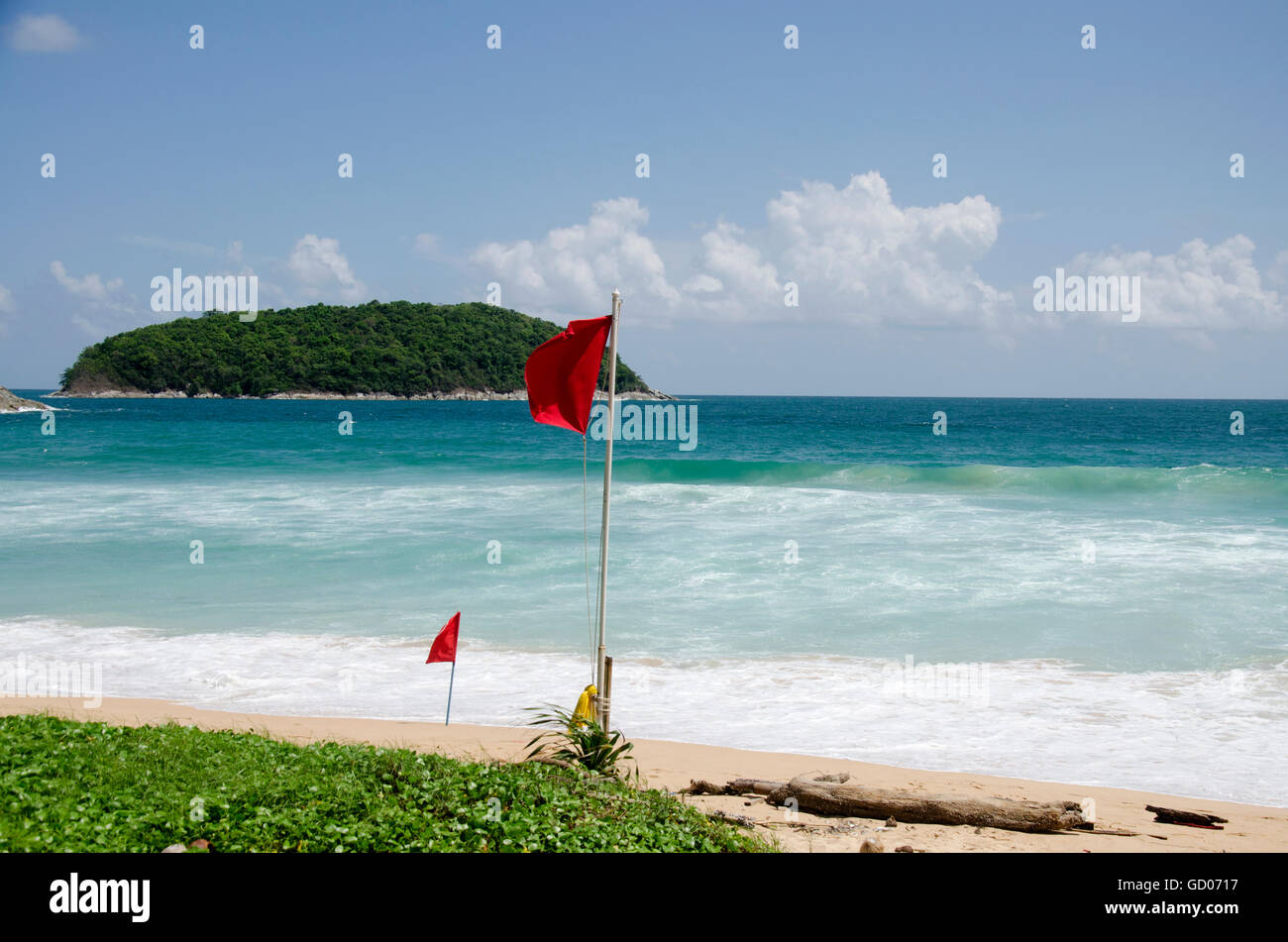 Beach warning red flags wind and wave rage at Nai Harn beaches of Phuket, Thailand Stock Photo