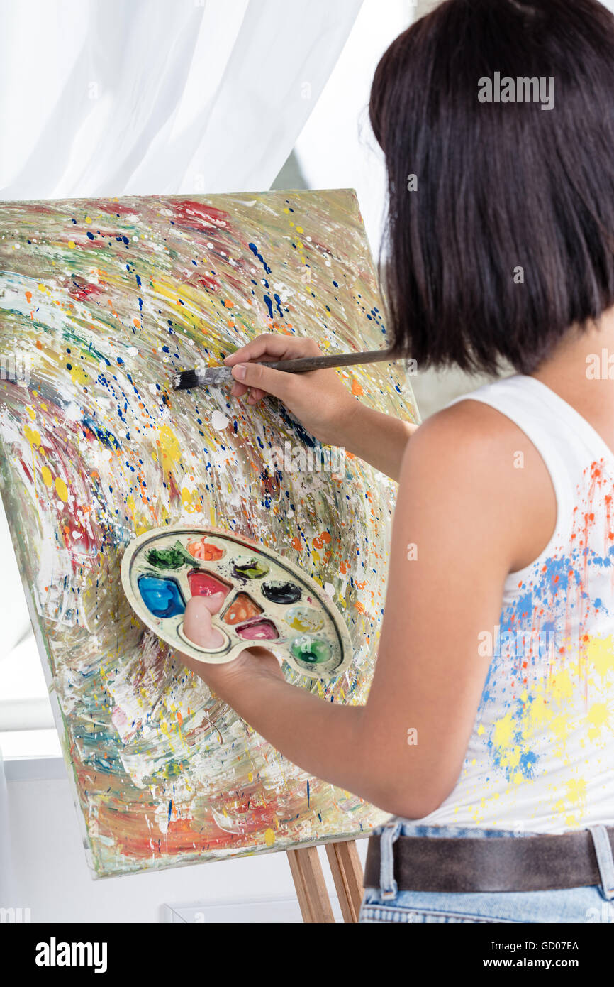 young woman with an easel paints a picture Stock Photo - Alamy