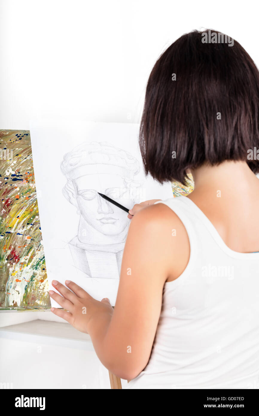 young woman with an easel paints a picture Stock Photo - Alamy