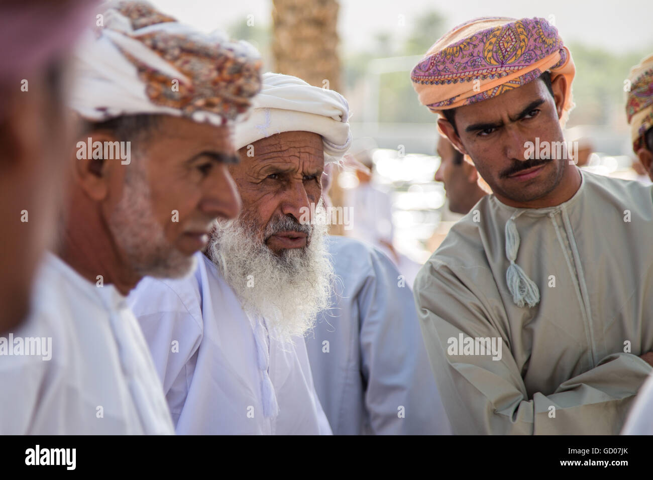 NIZWA, OMAN - APRIL 24 2015:Omani men at the traditional cattle market or souq in Nizwa, Oman. Stock Photo