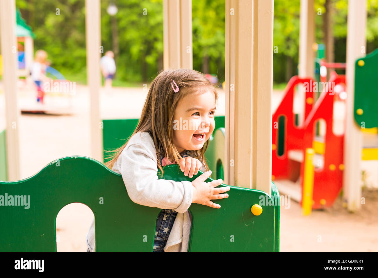 Little girl playing at the playground in the park Stock Photo - Alamy