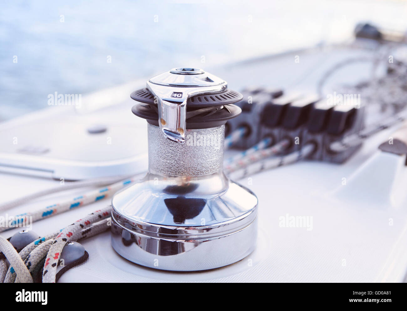 Yatch Forward Part Sailboat detailed parts. Close up on winch and rope of yacht over blue ...