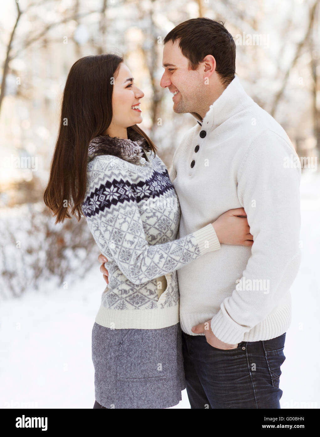 Happy young couple having fun in the winter park Stock Photo - Alamy