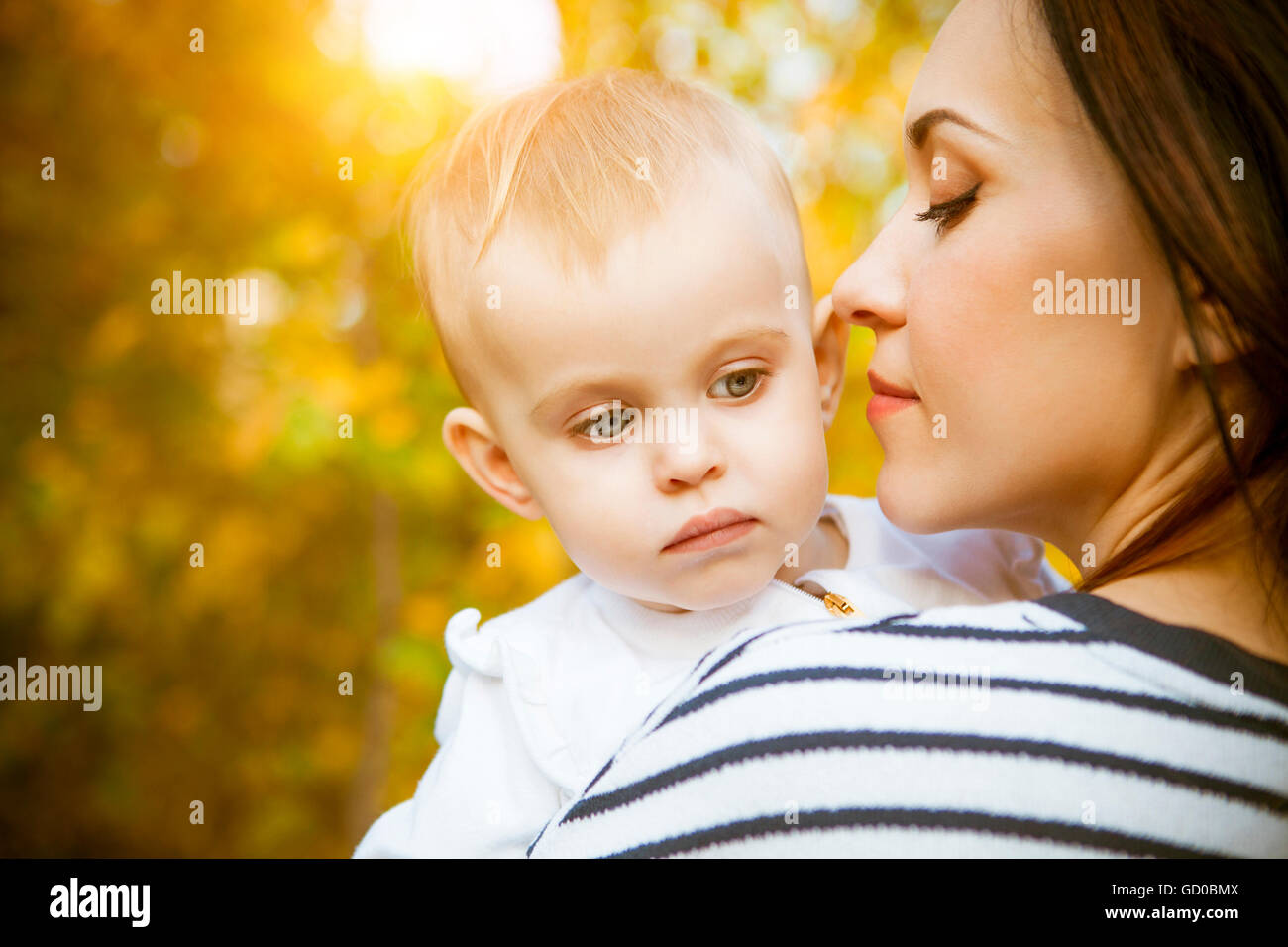 Young mother with her baby daughter in autumn park Stock Photo - Alamy