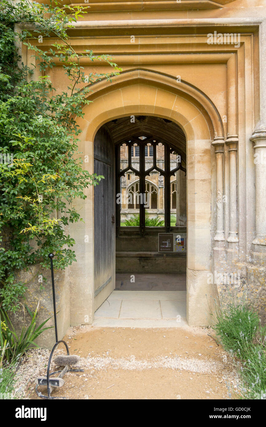 Open medieval door into the cloisters at Lacock Abbey, Lacock, Wiltshire, UK Stock Photo