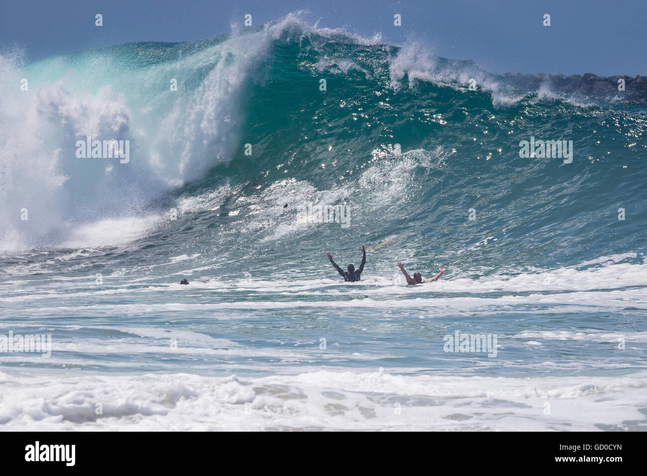 Body surfers swim out at the Wedge Newport Beach California in June