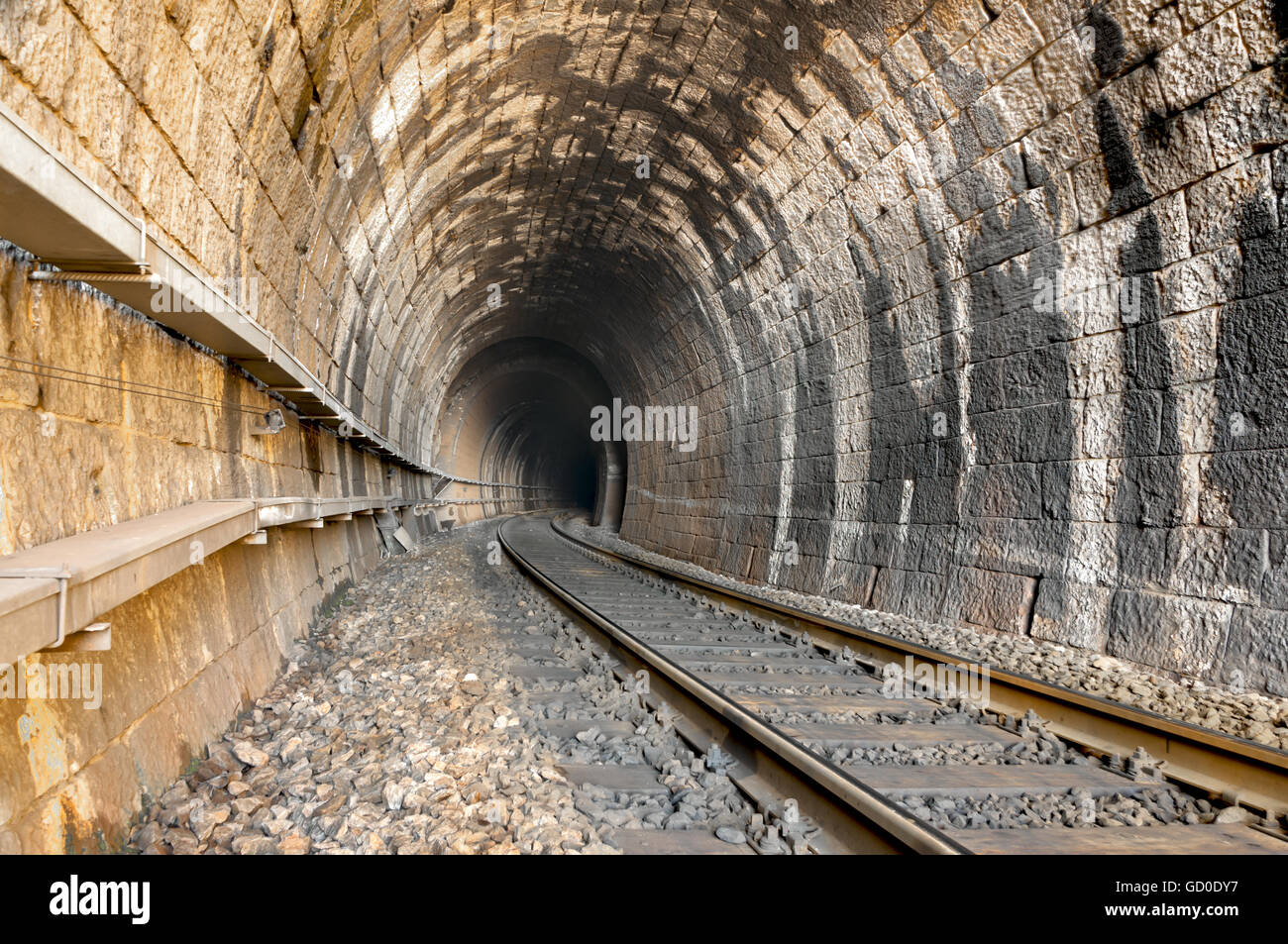 railroad tracks and old tunnel interior in dalmatian hinterland near labin, dalmatia, croatia Stock Photo