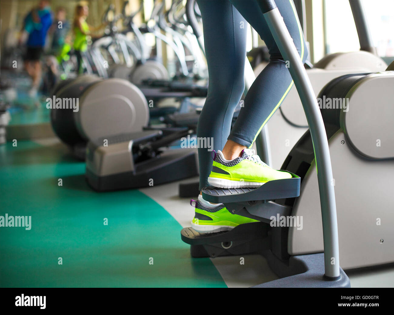 Young sporty women doing exercises in the gym centre. Closeup Stock Photo