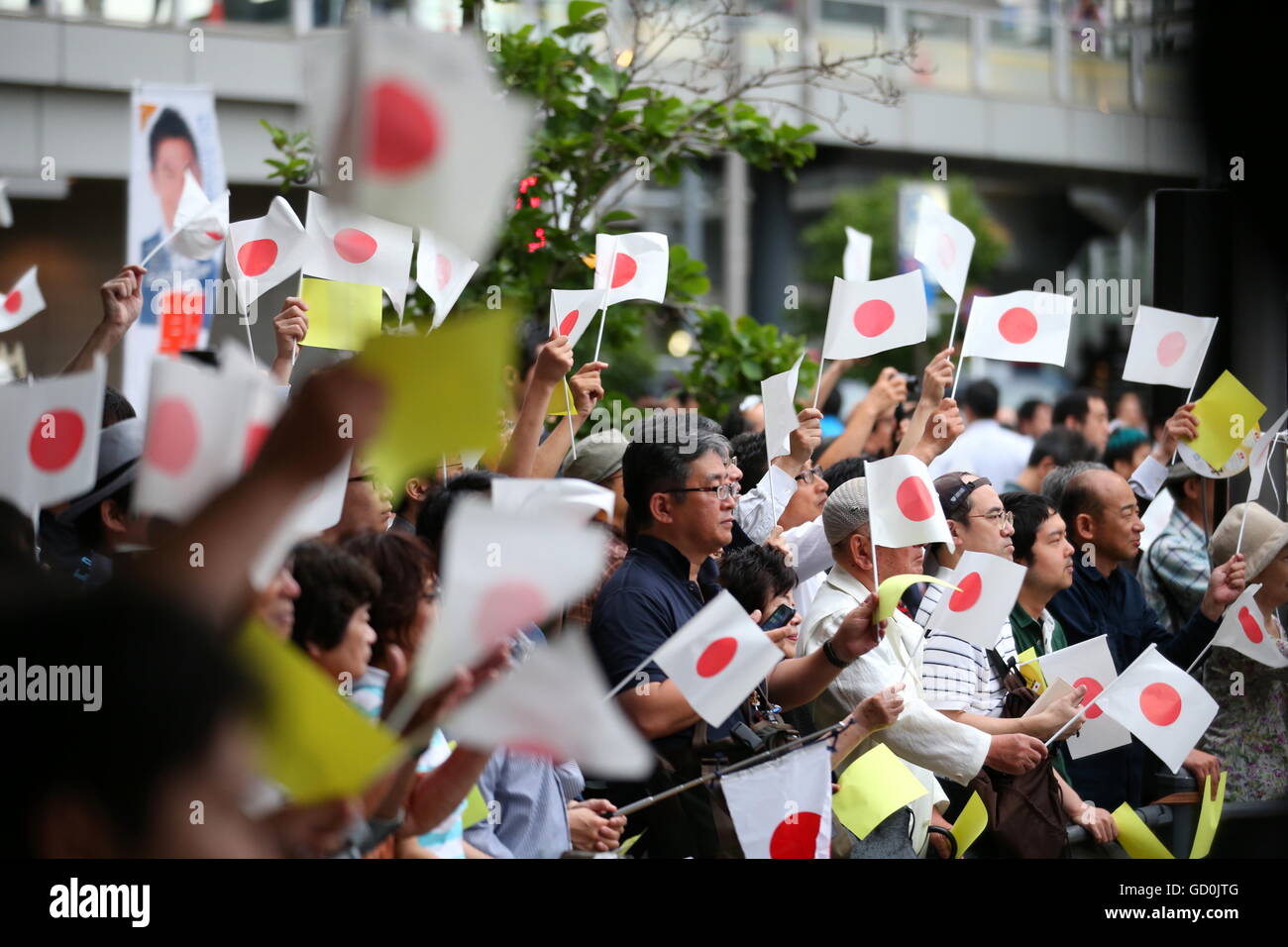People wave Japanese national flags as Japanese Prime Minister and ...