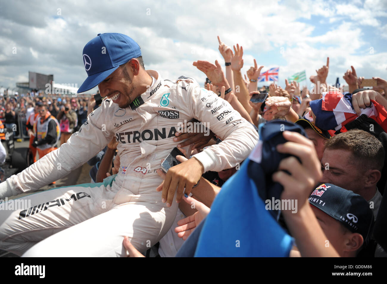 Silverstone, UK. 10th July, 2016. Lewis Hamilton does a crowd surf after winning the British grand prix. Credit:  Kevin Bennett/Alamy Live News Stock Photo