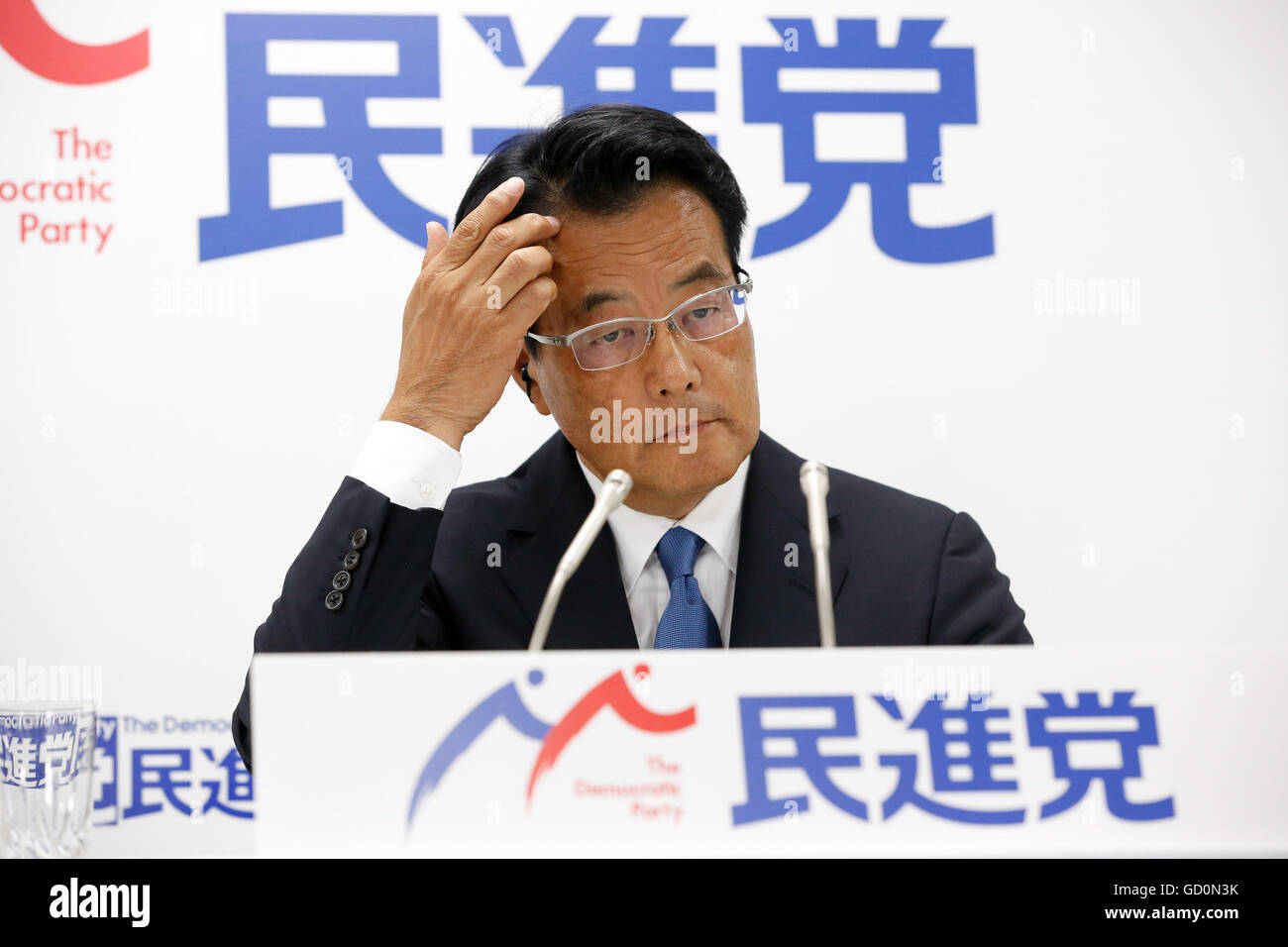 Tokyo, Japan. 10th July, 2016. Wry-faced Katsuya Okada, leader of Japans main opposition Democratic Party, comments on the early returns of Sundays upper house election during an interview with a Japanese TV station at the party headquarters in Tokyo on July 10, 2016. The Democrats linked up with three smaller parties including the Japanese Communist Party but failed to gain seats and block the pro-constitutional revision camp from getting a super majority as Prime Minister Shinzo Abes ruling coalition won a landslide victory. © Natsuki Sakai/AFLO/Alamy Live News Stock Photo