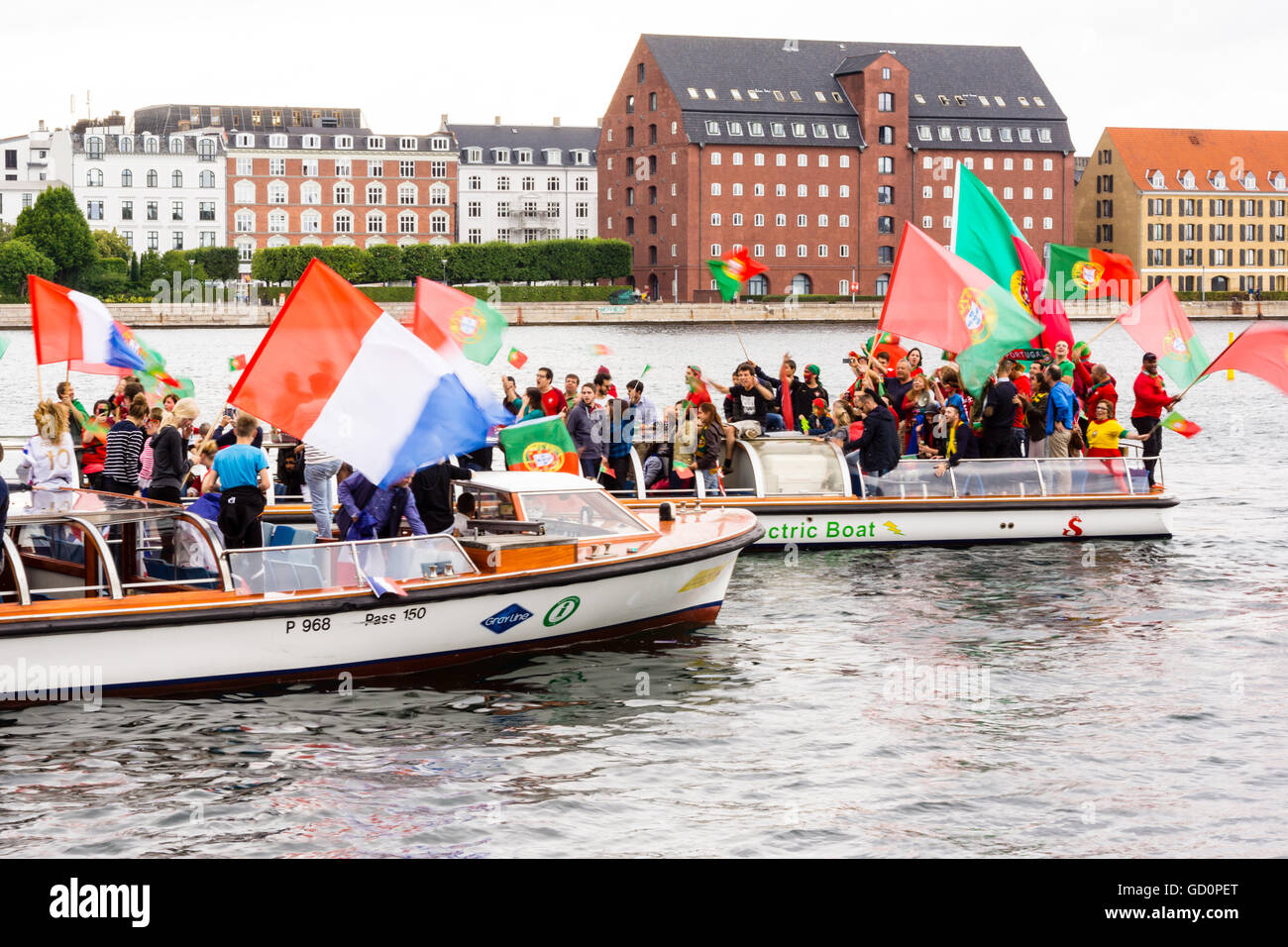 Copenhagen, Denmark. 10th July, 2016. Supporters from France and Portugal saling on canal boats in Copengaen, cheering and screaming at each other. Credit:  Stig Alenäs/Alamy Live News Stock Photo