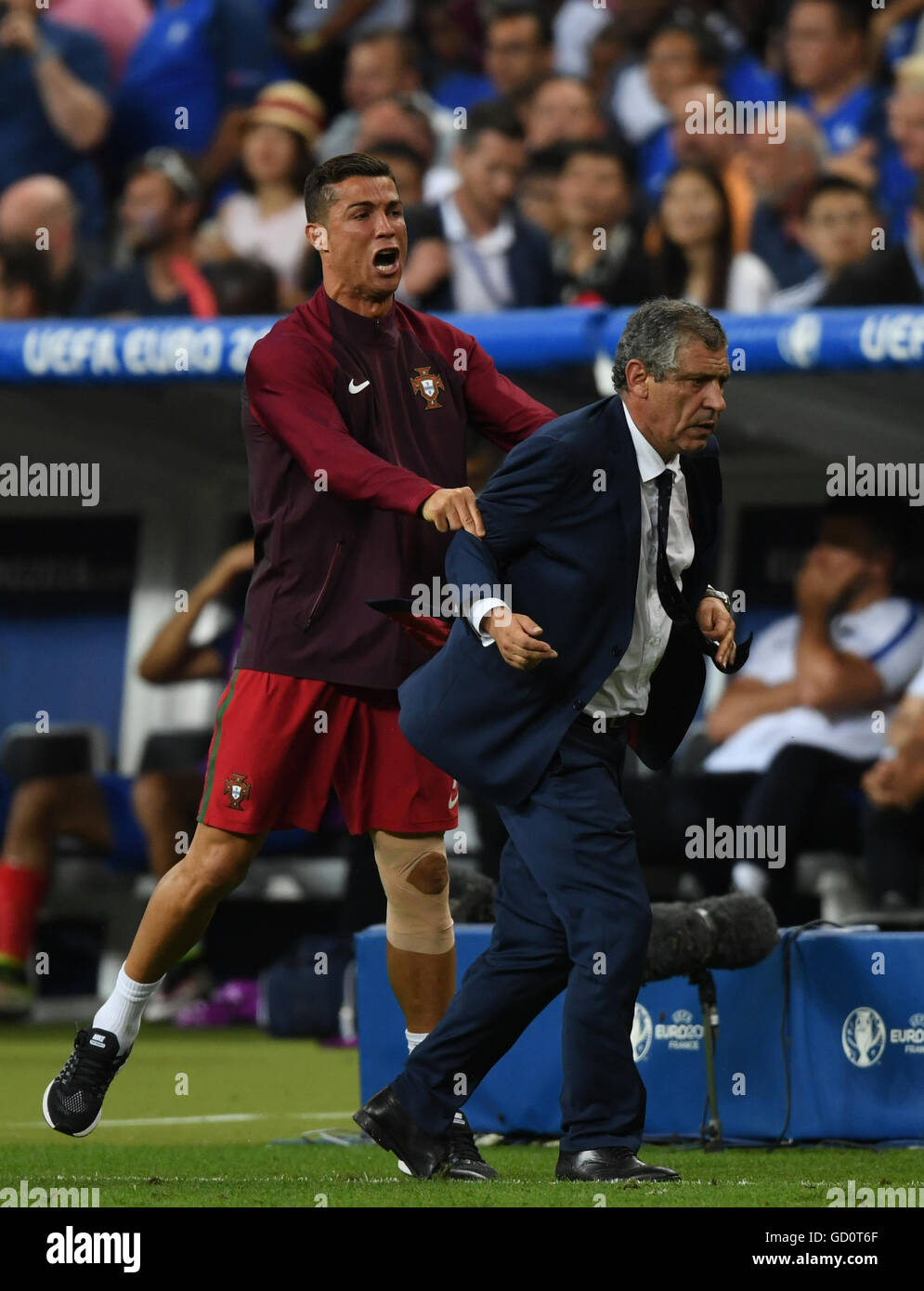 Paris, France. 10th July, 2016. Portugal's Cristiano Ronaldo(L) and  Fernando Santos coach of Portugal react after winning the Euro 2016 final  football match against France in Paris, France, July 10, 2016. Portugal