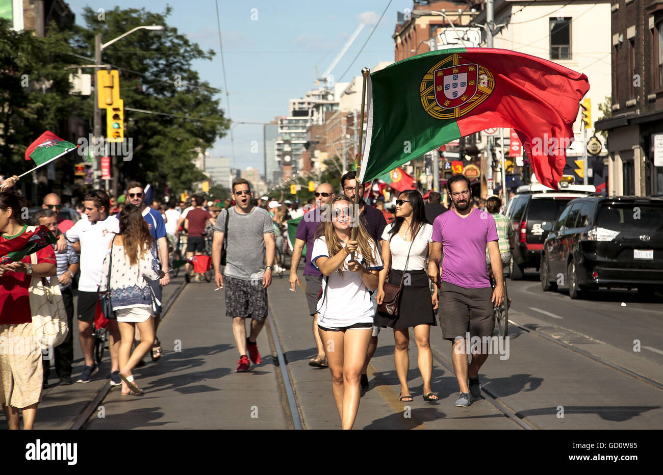 Toronto, Ontario, Canada. 10th July, 2016. Fans of the Portugal team, take the streets in downtown Toronto around College Street, partying after Portugal wins the Eurocup Finals. Portugal win the match against France 1-0 at the Stade de France in Paris, Toronto fans flooded the streets, singing, blowing whistles and waving Portuguese flags. © Joao Luiz De Franco/ZUMA Wire/Alamy Live News Stock Photo