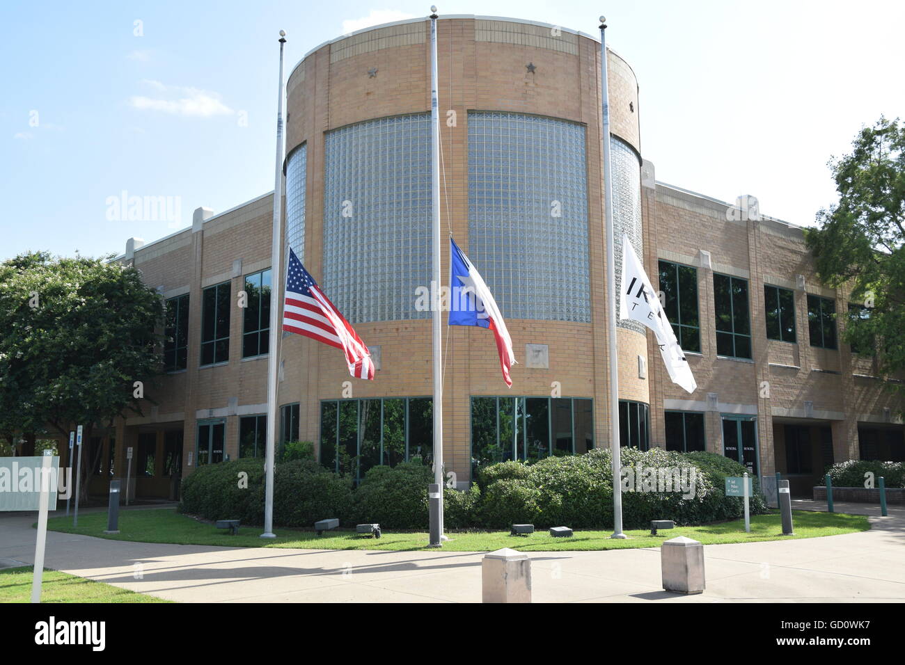 Local police departments, like this one in Irving, show support for 5 slain police officers with flags at half staff and ribbons. Credit:  Hum Images/Alamy Live News Stock Photo