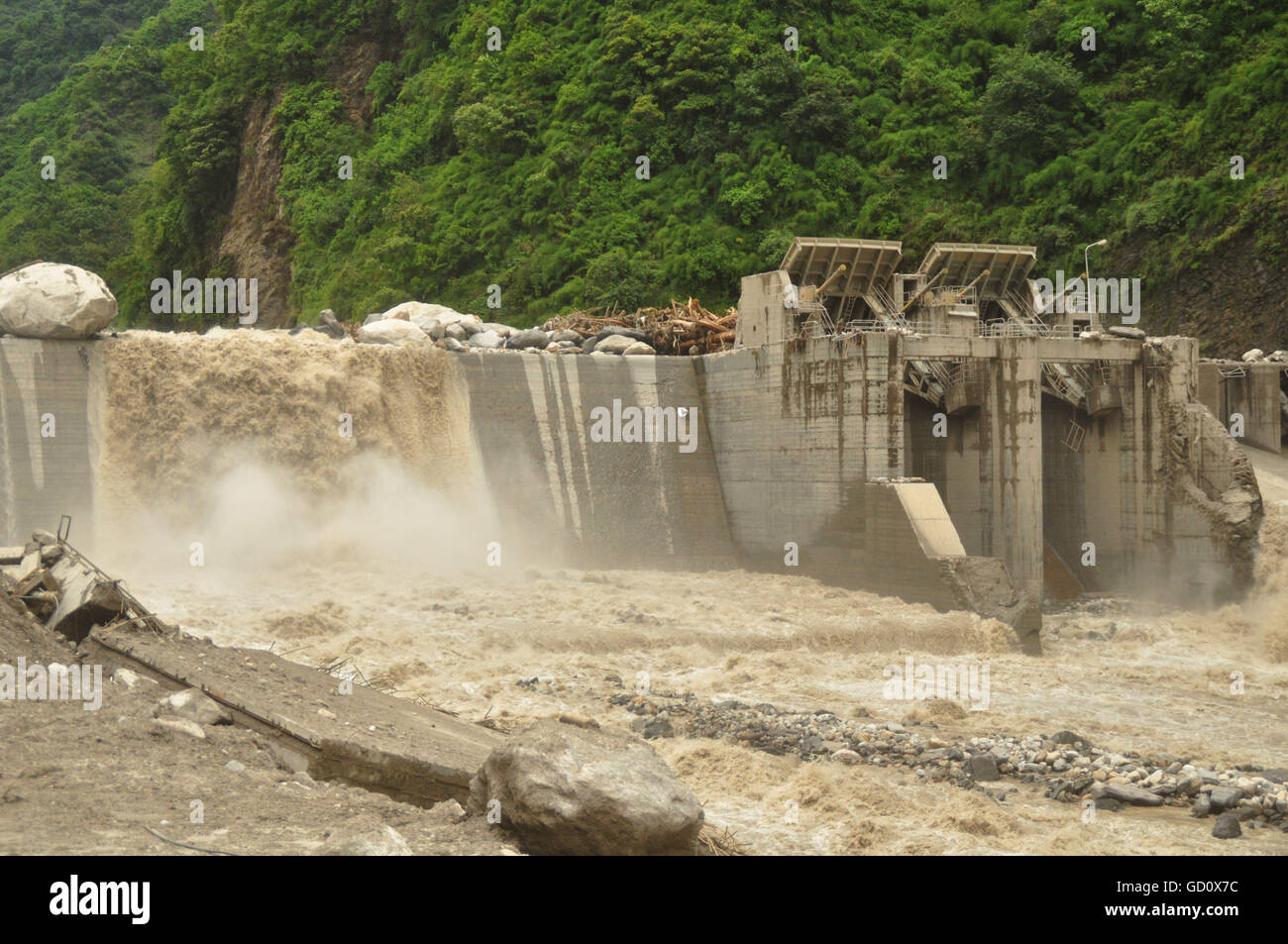 (160711) -- SINDHUPALCHOWK (NEPAL), July 11, 2016 (Xinhua) -- Photo taken on July 10, 2016 shows the damaged dam of Upper Bhotekoshi Hydropower Project on the Bhotekoshi River in Sindhupalchowk, Nepal. The flood in the Bhotekoshi River has caused land erosion in multiple sections of Araniko Highway and swept way many houses in Tatopani and Liping. (Xinhua/Dinesh Bikram Shah) Stock Photo