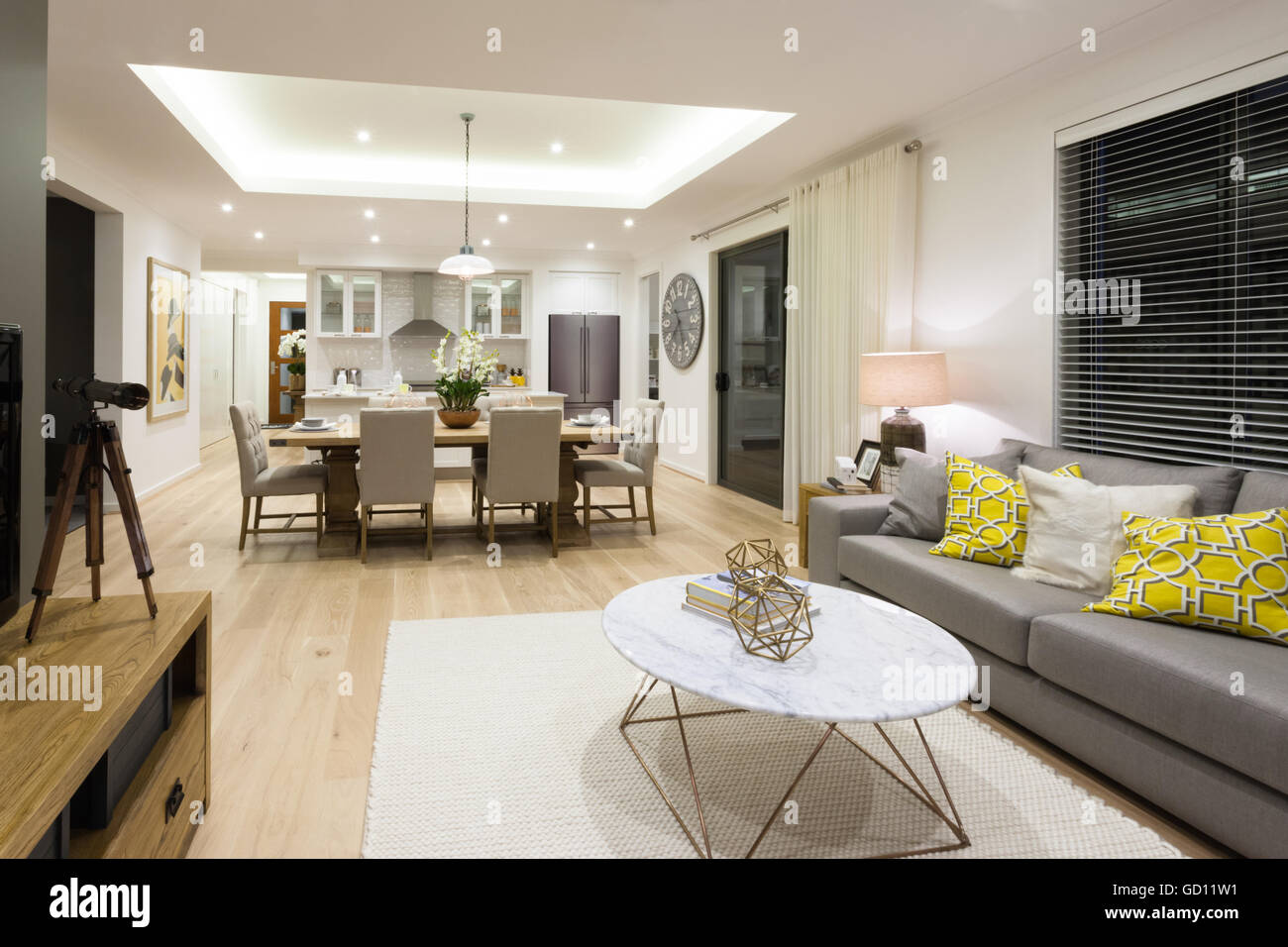 Modern living room including sofas, chairs and tables beside the