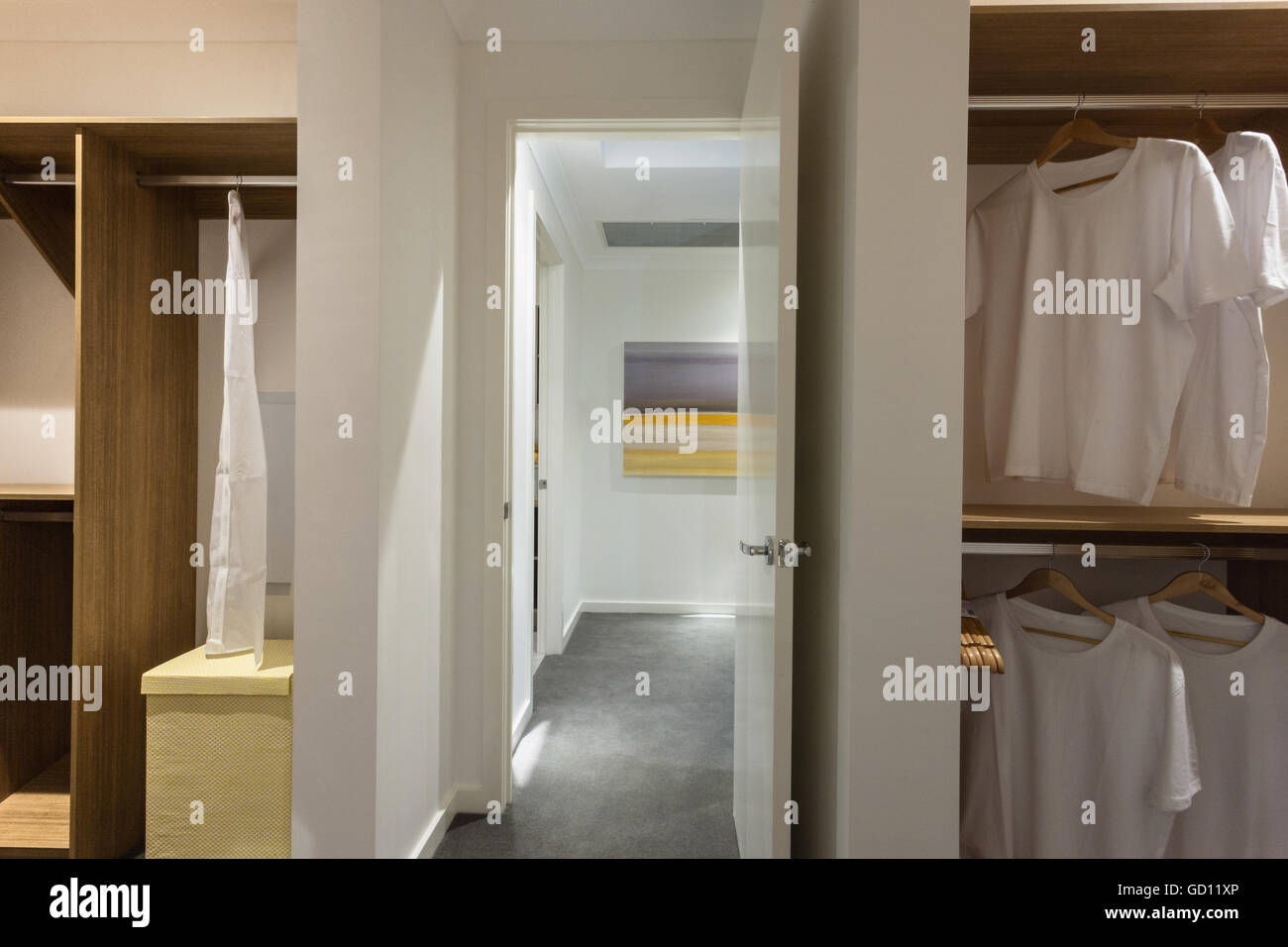 Laundry Room With A White Shirt Hanging In Wooden Cupboards Of A